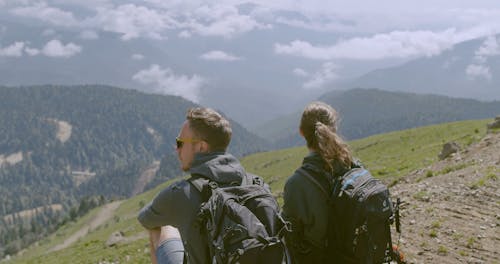 A Couple Enjoying The View From A Mountain Top