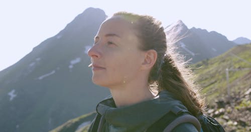 A Couple Feeling The Breeze In Hiking A Mountain