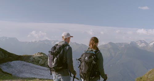 A Couple Seeing A Scenic View From The Mountain Top