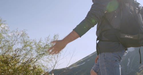 A Man Helping His Partner In Their Hiking