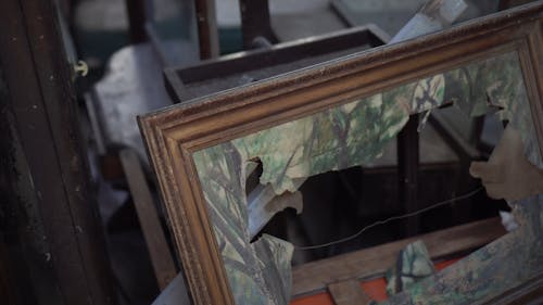 Broken Picture Frame And Old Furnitures In A Room