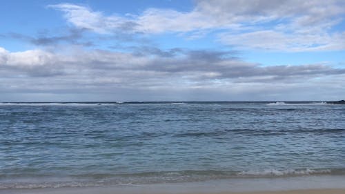 View Of The Sea Under A Blue And Clousy Sky