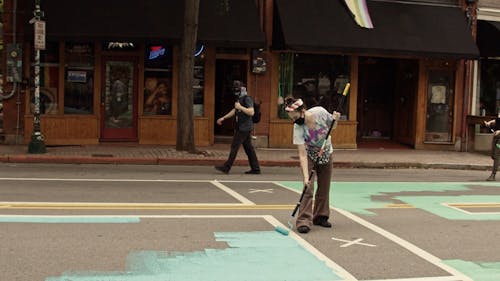 A Woman Painting The Street
