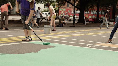 Group Of People Making A Street Mural