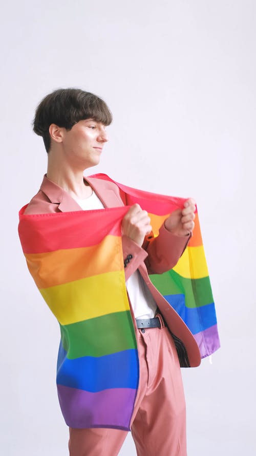 Man Dancing and Holding a Gay Pride Flag