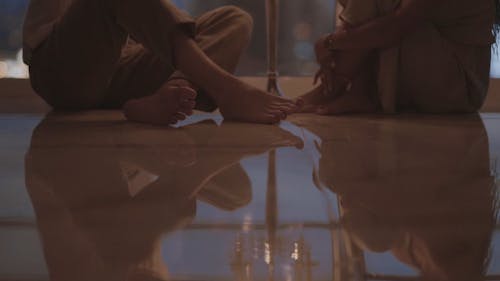 Young Couple Sitting on the Floor with Candle Lights