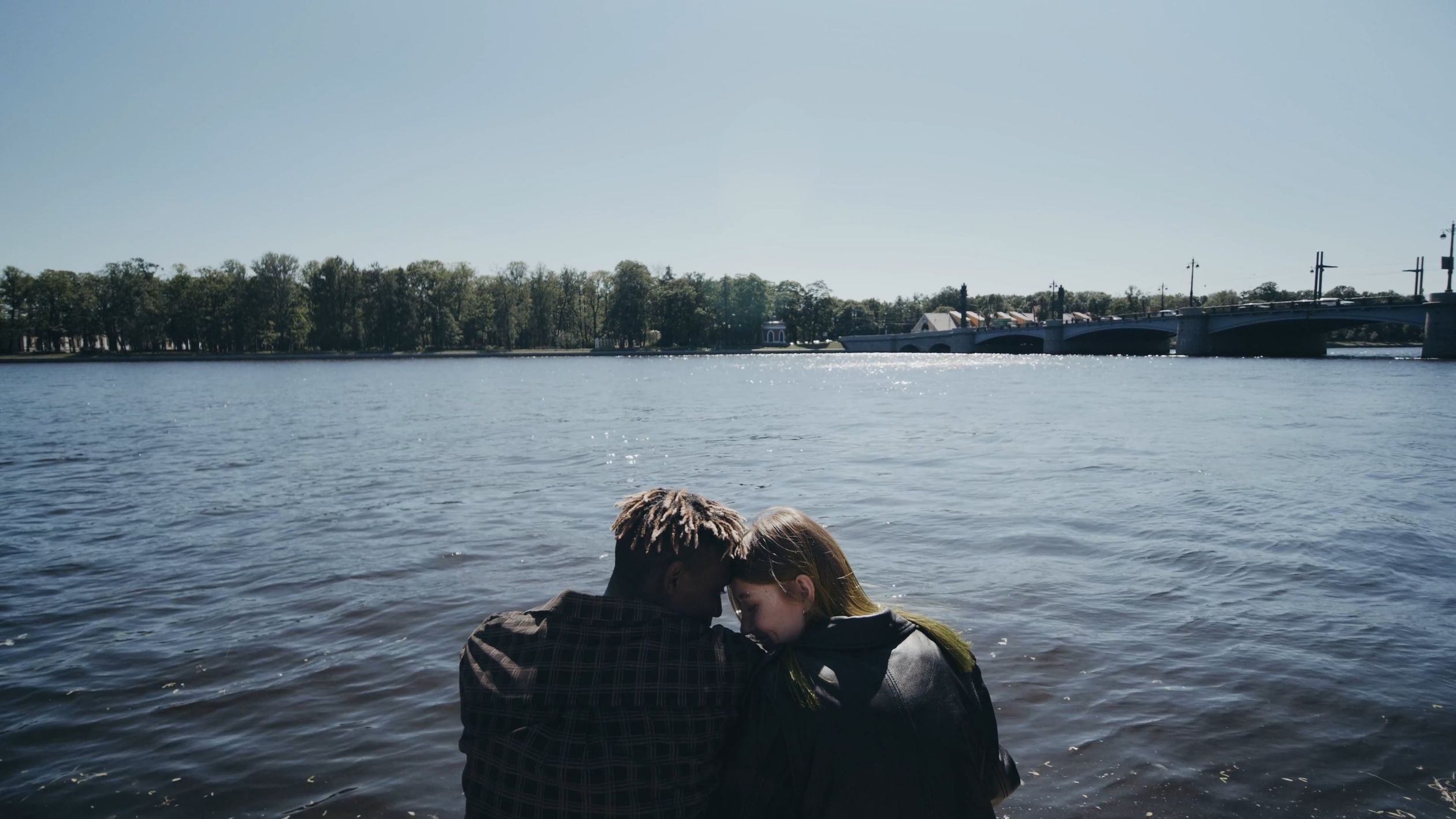 Couple sitting on the edge of a body of water Free Stock Video Footage ...