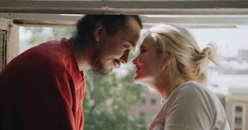 Couple Looking at Each Other While Laughing