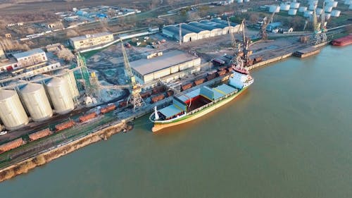 Loading A Docked Cargo Ship With Coal