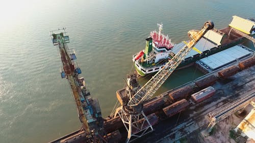 Drone footage Of A Docked Cargo Ship At The Loading Area