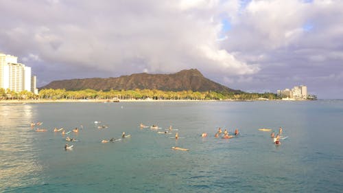 Surfers Waiting For Waves In The Open Sea