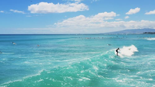 Tracking Shot Of A Surfer Riding A Sean Wave