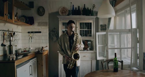 A Man Playing A Saxophone In The Kitchen