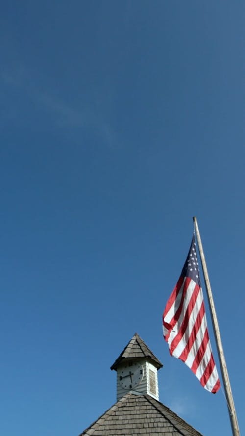American Flag Waiving Over Clock Tower