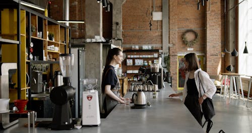 A Customer Getting Her Brewed Coffee