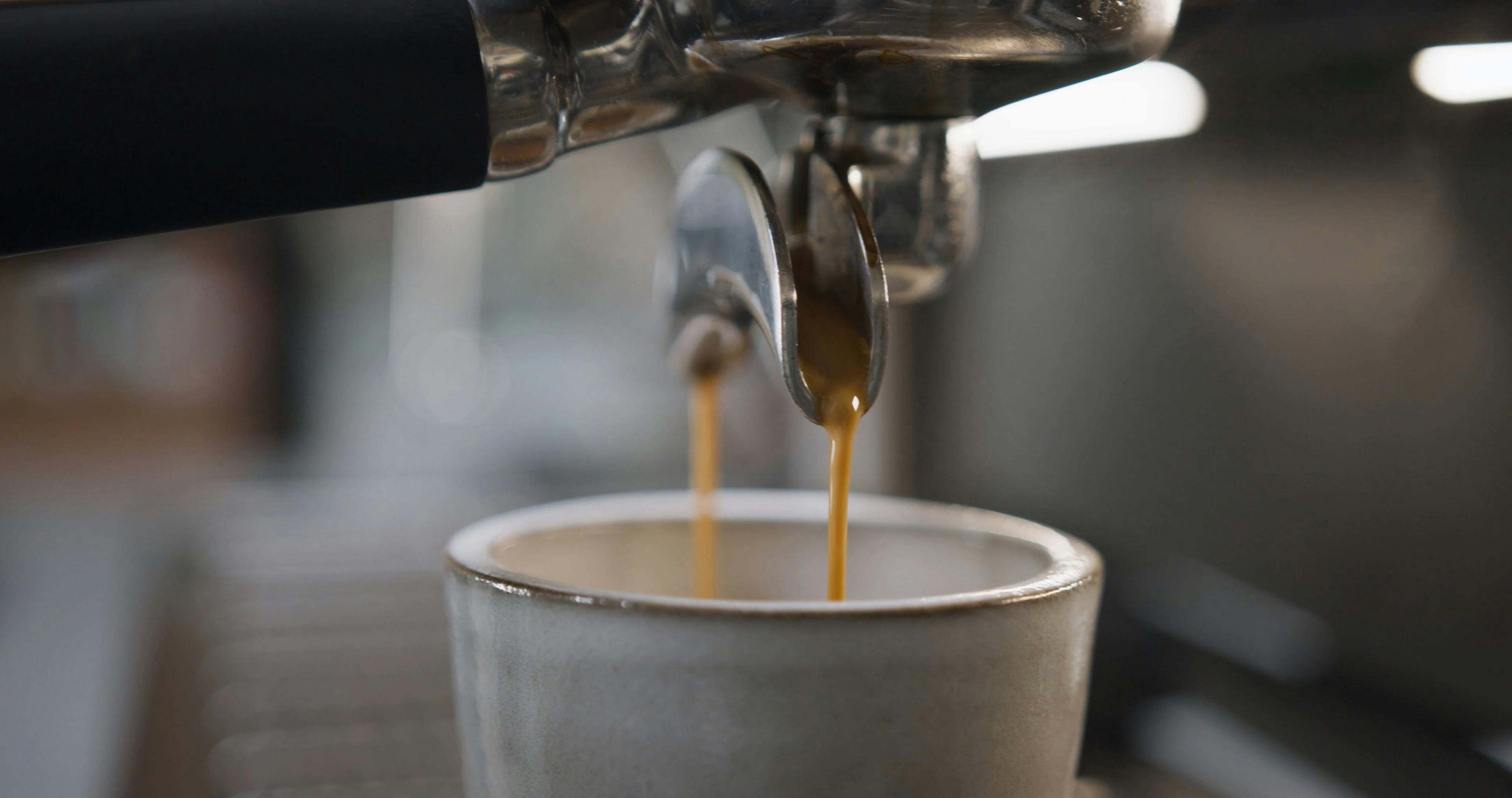 A Coffee Dripping in a Cup from the Coffee Maker · Free Stock Video