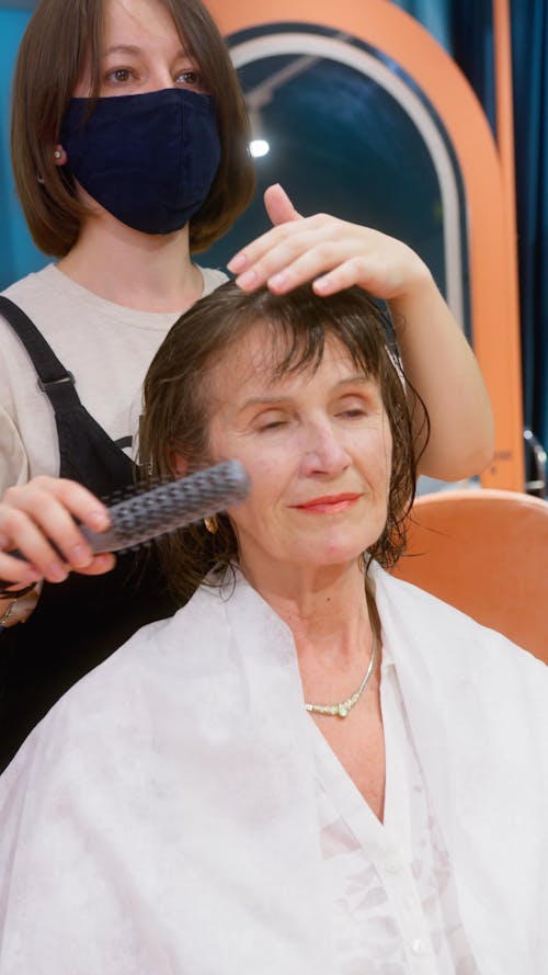 Woman Brushing the Hair of Another Woman