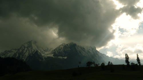 Thick Clouds Formation Over The Snow Capped Mountain