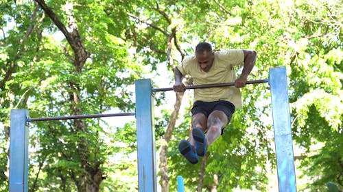 A man Lifting Himself Over The Pull Up Bar