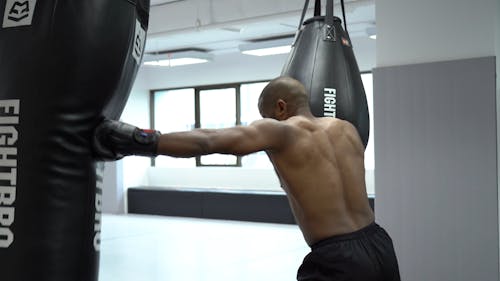 A Man Punching The Heavy Bag