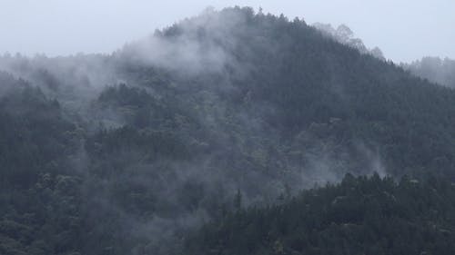 Drone Footage Of Thick Fog Creeping In The Mountain Side