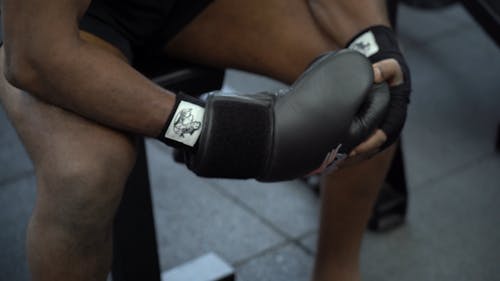 Person Putting on Boxing Gloves