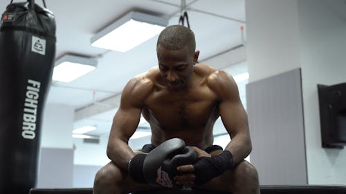 Man Putting on Boxing Gloves