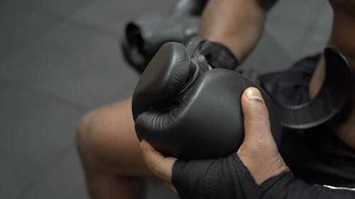 Close-Up View of Person Putting on Boxing Gloves