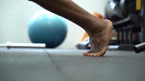 Feet Of A Man Doing Push Up Exercises