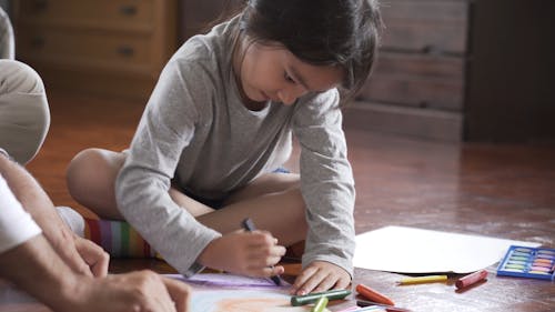 Girl Coloring Her Artwork