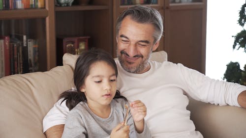 Dad Watching Her Daughter Eat