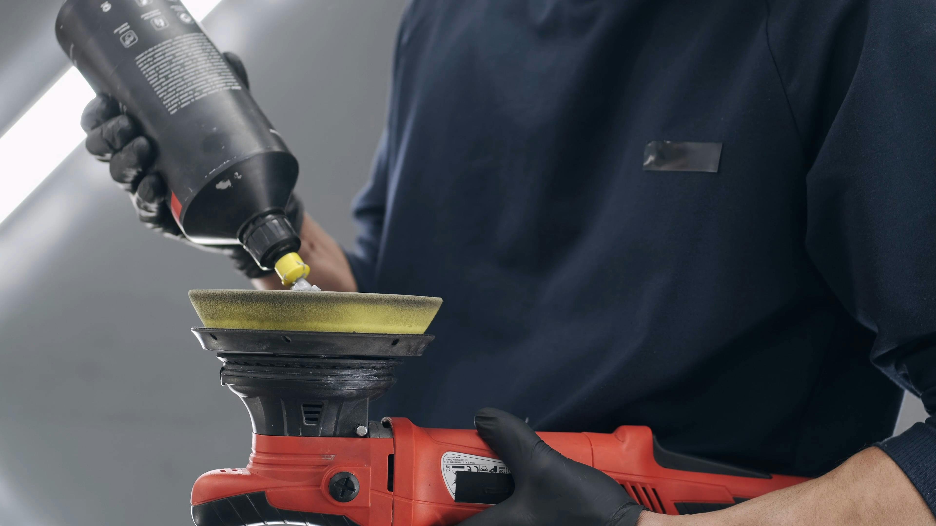 A Man Putting Polishing Compound on a Rotary Polisher · Free Stock Video