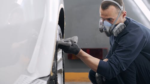Man Cleaning Car Wheel