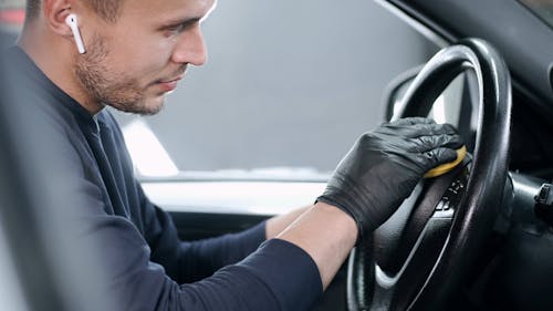 Man Cleaning the Steering Wheel