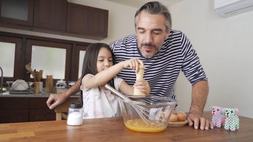 A Little Girl Preparing A Scramble Egg Meal