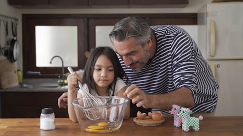 Dad Cracking Eggs For Her Daughter