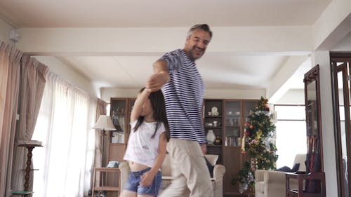 A Father Dancing With Her daughter