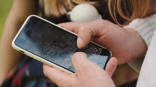 Person Using a Map through His Smartphone