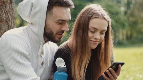 Man and Woman Using a Smartphone