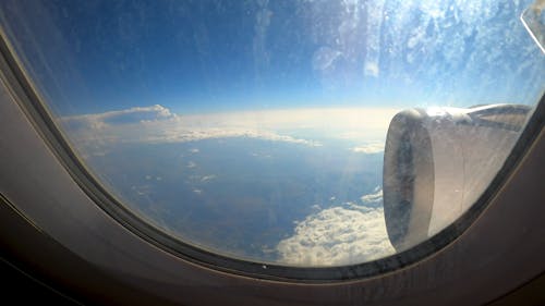 An Airplane Flying Above he Clouds