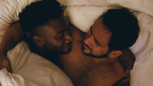 Men Couple Looking at Each Other Then Covers Themselves With White Blanket