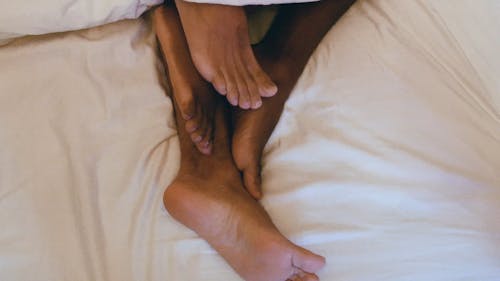 Two Persons Feet Cuddling Together