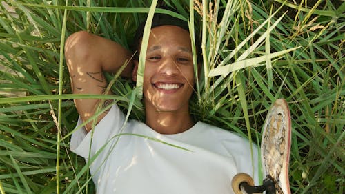 A Young Man Lying Down On Wild Grass