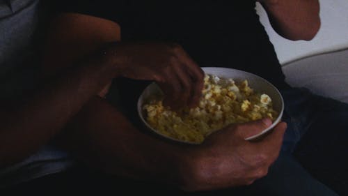 Two Persons Eating a Popcorn