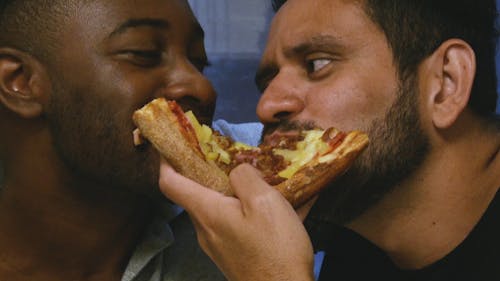 Men Couple Eating a Pizza