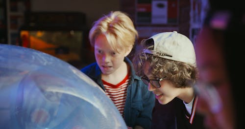 Young Teenagers Playing An Arcade Game Machine