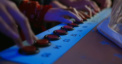 Hands On The Control Buttons Of A Gaming machine