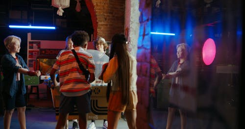 Teenage Kids Playing In An Arcade