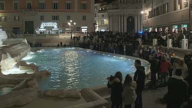 people surrounding the trevi fountain in rome