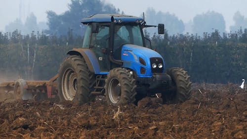 A Tractor Plowing the Field